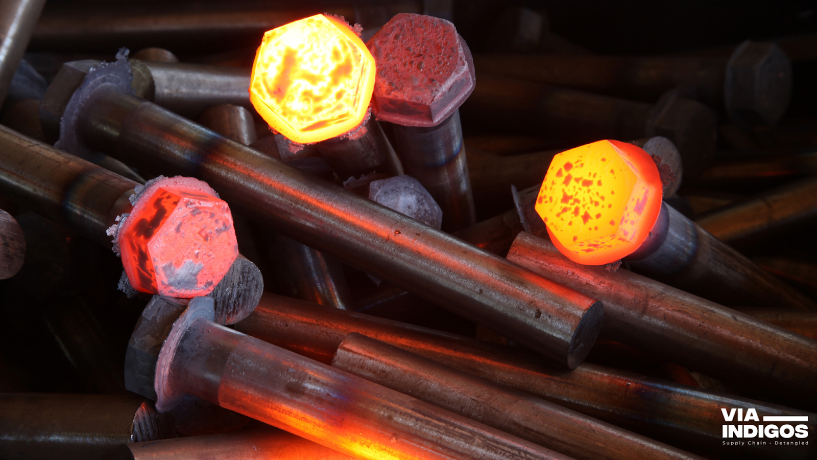 Hot forged fasteners under the forging process.